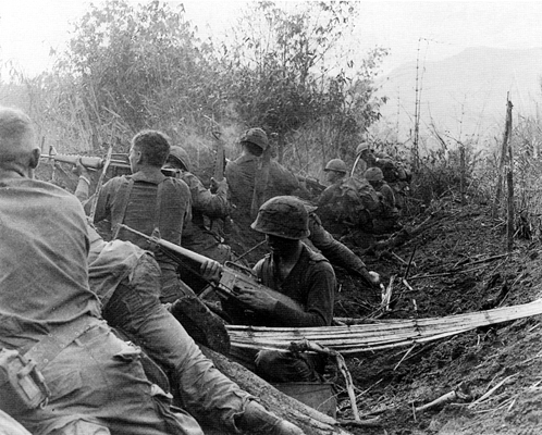 Picture - Men of the 1st Brigade, 101st Airborne Division, fire from old Viet Cong trenches.