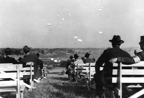 Picture - Paratroopers stage a special demonstration for members of Congress, Fort Belvoir, Virginia, 1941.