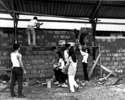 PICTURE - STUDENT VOLUNTEERS help construct a dormitory for roar orphans at the Buddhist Institute, Saigon.