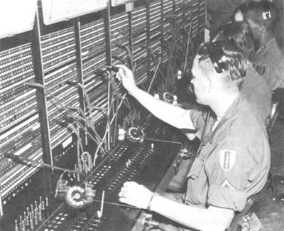 Photograph: Signalmen Operating A Large Manual Telephone Switchboard at Saigon