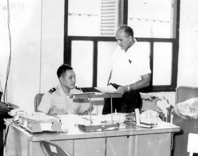 Photo: VIETNAMESE CHIEF OF THE COMBINED INTELLIGENCE STAFF CONFERRING WITH DEPUTY FROM THE OFFICE OF THE SPECIAL ASSISTANT, U.S. EMBASSY.