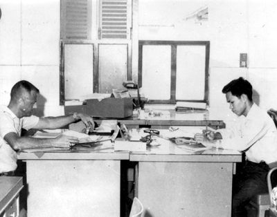 Photo: DI AN DESK TEAM checking blacklist against a list of apprehended Viet Cong.