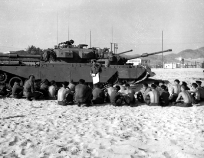 PICTURE - TROOPS OF 1ST AUSTRALIAN ARMOR REGIMENT IN FRONT OF AUSTRALIAN CENTURION TANK receive briefing at Vung Tau.