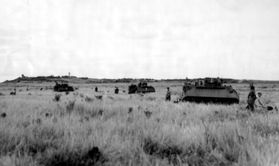 PICTURE - PREPARING NIGHT DEFENSIVE POSITIONS ALONG THE DEMILITARIZED ZONE. Men of 1st Battalion, 61st Infantry, dig foxholes but vehicles are left in the open to allow maneuver.