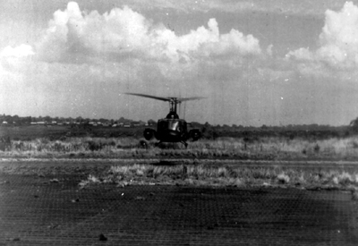 PICTURE - UH-1B HELICOPTER WITH TOW MISSILES lifts off strip at Pleiku.
