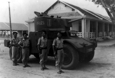 PICTURE - SOUTH VIETNAMESE ARMORED RECONNAISSANCE UNIT stands inspection in 1952 at Thu Duc Officers School. The vehicle is a 1939 French Panhard armored car.