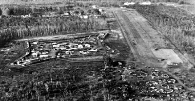 PICTURE: CIDG Compound and Loc Ninh Airstrip with A Battery, 6th Battalion, 
  15th Artillery, position in the foreground.