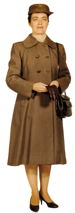 Plate 20. Officer in the double-breasted wool serge taupe overcoat (1951-1968), with button-in lining that could also be worn in the taupe raincoat. The coat was worn with the wool taupe hat or garrison cap, cafe brown leather purse, cafe brown pumps or oxfords, and gloves. Enlisted woman also wore this overcoat.