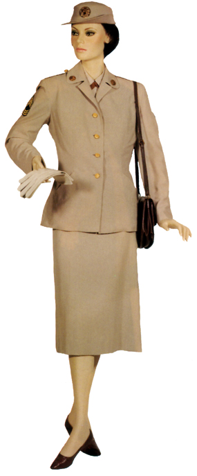 Plate 26. Enlisted woman in the optional purchase Army beige uniform (19541968), made in a tropical worsted or gabardine fabric. This summer uniform was worn with cafe brown accessories until 1962, when black accessories were prescribed. This uniform, sometimes called "the silver taupe," was also worn by officers.