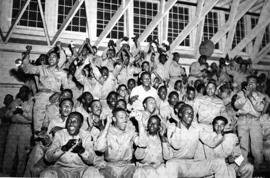 Photo: WATCHING A BOXING MATCH AT CAMP CLAIBORNE, LA., 1942
