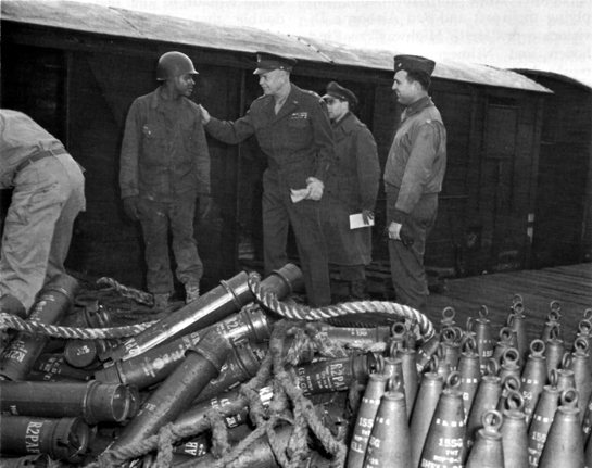 Photo: GENERAL EISENHOWER TALKS TO AN AMMUNITION HANDLER AT CHERBOURG