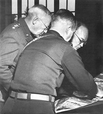 Photograph: Patton Confers with Eisenhower on plan for reduction of Fort Driant. On the left is General Patton, on right General Eisenhower. 