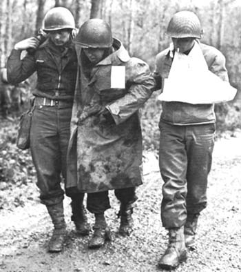 Photograph: Wounded Soldier Helped To Aid Station, after fighting in the Forêt & de Grémecey.