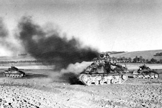 Photograph: American Tank Damaged By German Fire. This tank of the 8th Tank Battalion was hit during the German counterattack to destroy the Bayon Bridge.