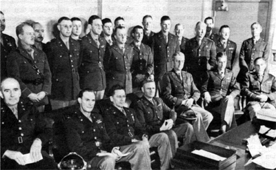 Photo - MAJ. GEN. T. T. HANDY, Assistant Chief of Staff, Operations Division, and other planners of the division. Sealed left to right: Col. C. A. Russell, Col. J. E. Upston, Brig. Gen. P. H. Tansey, General Handy, Brig. Gen. A. C. Wedemeyer, Col. 1;. R. Partridge, and Col. R. F.. Starr; standing left to right: Col. R. C. Lindsay, Col. V. H. Connor, Col. F. L. Fair, Col. J. C. Blizzard, Jr., Col. C. W. Stewart, Jr., Col. b1'. 1.. Ritchie, Lt. Col. E. B. Gallant, Col. D. 1'. Johnson, Col. H. 1. Hodes, Col. 7'. S. Timberman, Col. L. Mathewson, Col. G. Ordway, Jr., Col. C. K. Gailey, Jr., Col. C. D. Silverthorne, Col. W. C. Sweeney, Jr., Col. .T North, and Col. R. T. Maddocks.