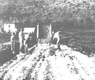 Photo: Engineers spread rock...