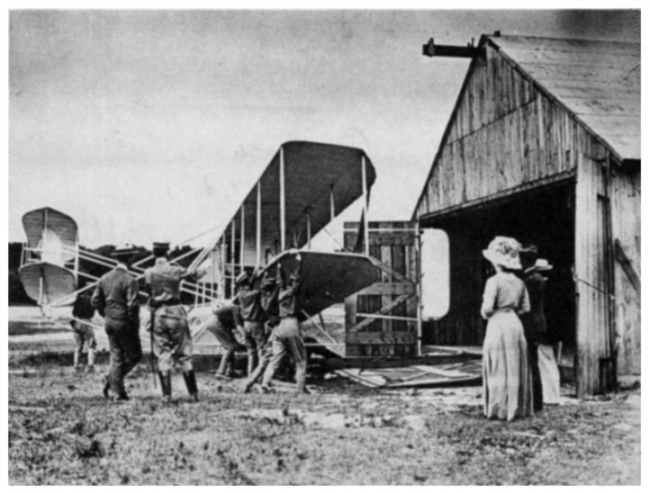 soldiers carrying Wright plane to runway