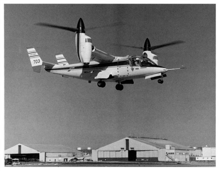 tilt rotor aircraft hoovering above airfield