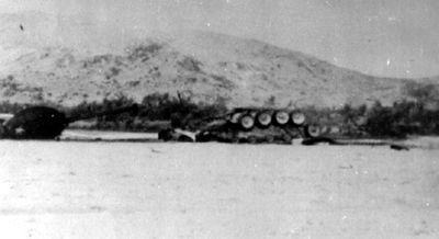 PICTURE - M48A3 TANK EXPLODES A 750-POUND BOMB SET UP AS A MINE. Turret was hurled from tank, which was blown out of its tracks.