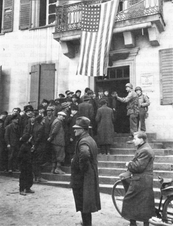 GERMANS QUEUE UP for information and advice at a military government detachment headquarters.