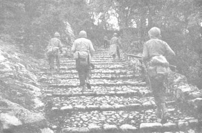 Photo: An American Patrol Follows a Stone-paved Trail
